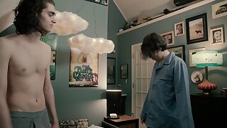 Young guy with long hair texting from the bathtub