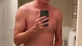 Matthew shoots his cum in the mirror.