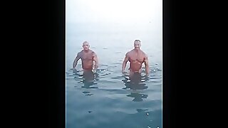Muscle Daddy with inked friend coming out of the Mediterranean