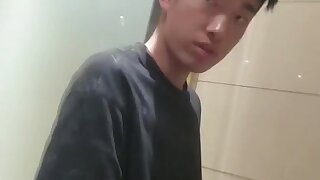 A male student is pissing in the toilet 5.