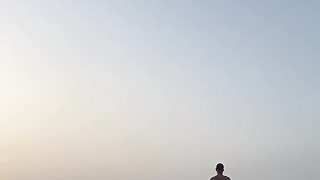Athletic guy on the beach running to the sea