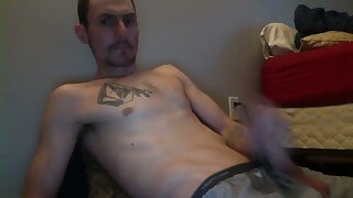 He jerks off in his boxer underwear though the fly and cums on his chest and stomach
