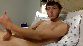 He jerks off his cock in bed while showing off his ass and hole